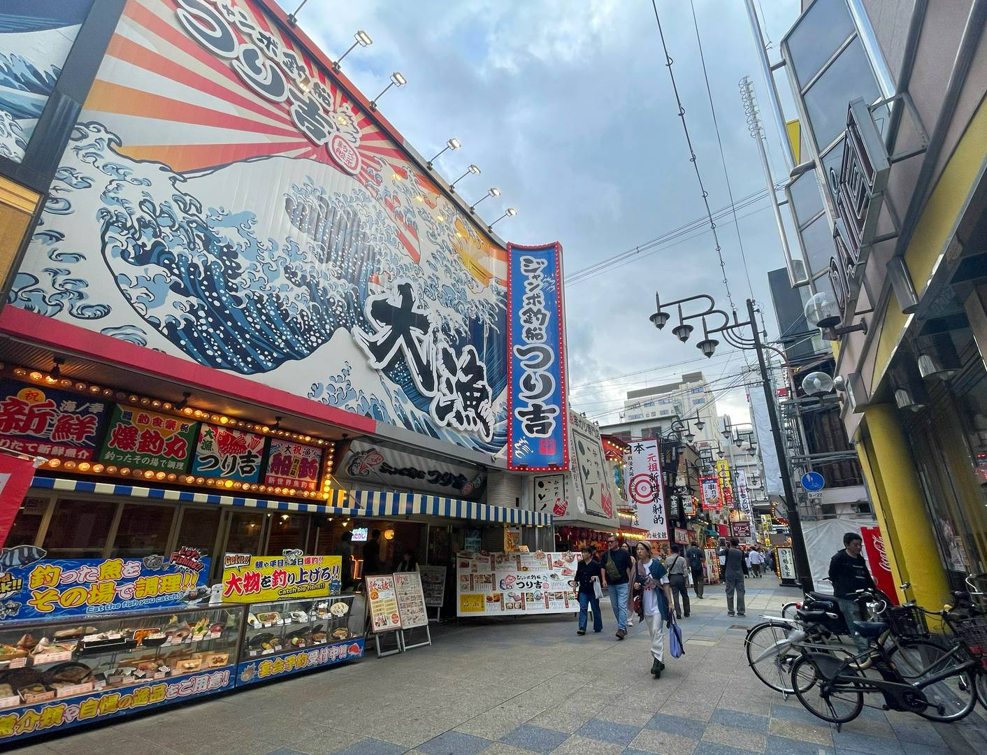 Lively Japanese street with vibrant signs and bustling crowds