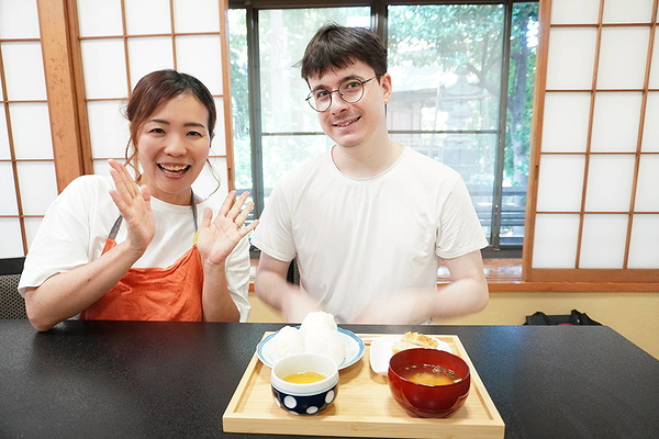 Cultural culinary experience with traditional Japanese meal and happy guests.
