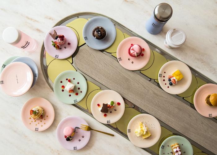 Desserts on conveyor belt.