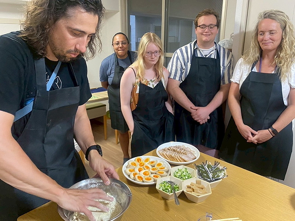 Cooking class group learns to make bread dough from scratch
