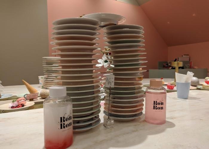 Two tall stacks of dessert plates that looks like twin towers.