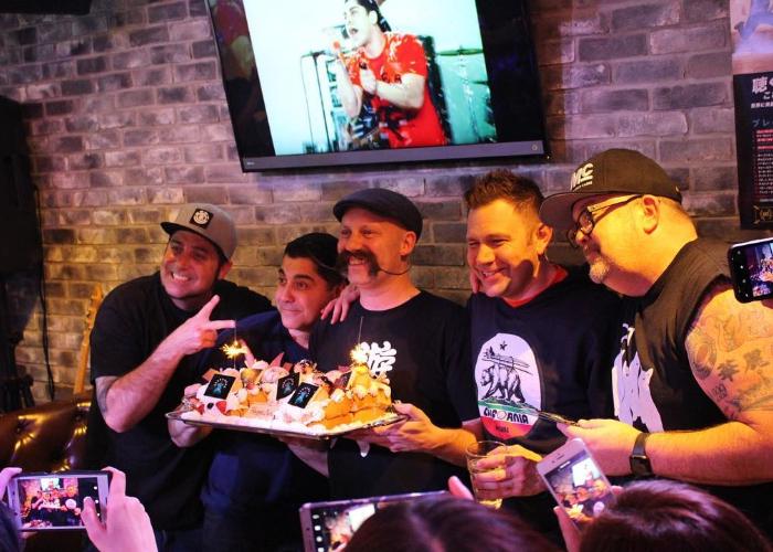 People holding party and enjoying honey toasts in karaoke room.