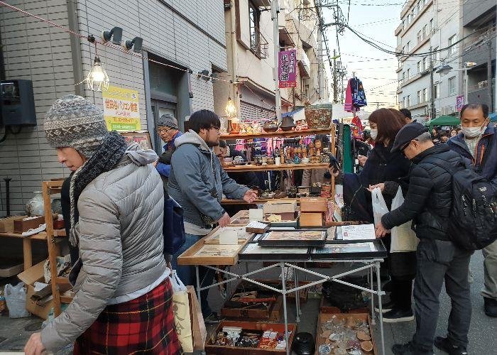 Crowds of people gather around home goods at Boroichi Market 
