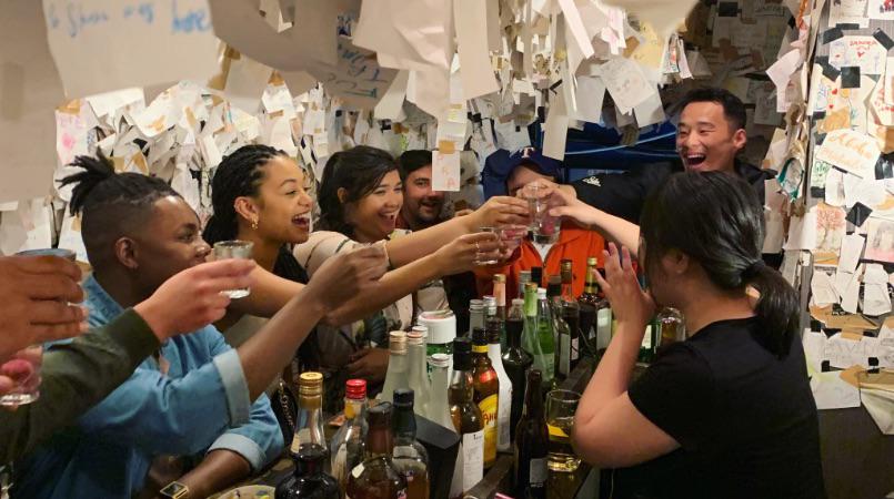 Guests in this Shinjuku bar-hopping tour, raising their drinks in celebration.