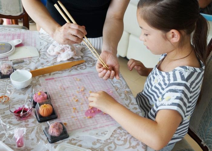 Little girl making Japanese wagashi, a vegan traditional sweet