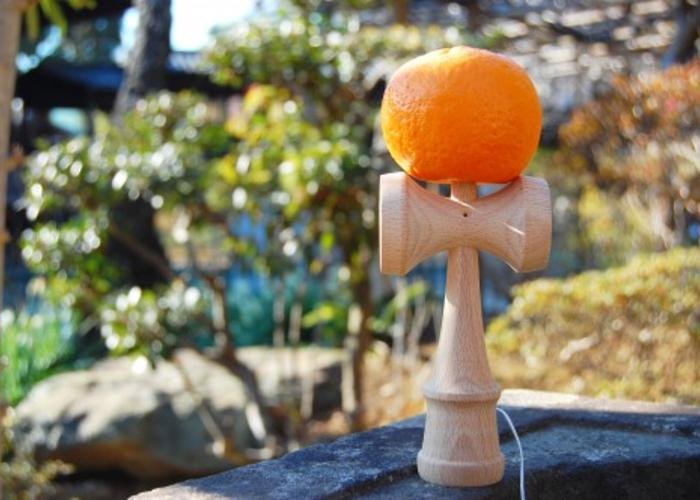 Traditional Japanese game, Kendama, including a ball speared on a stick