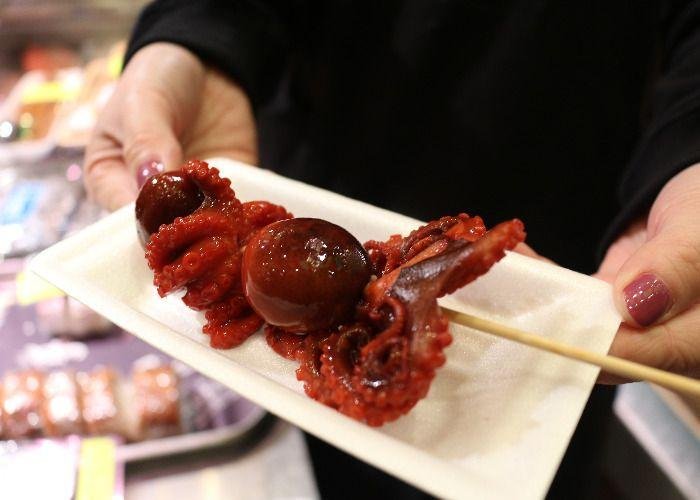 A whole baby octopus cooked with its hread filled with a quail's egg