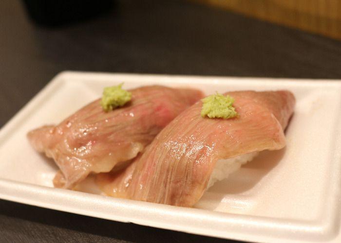 Sirloin beef sushi slices on rice with a tip of wasabi