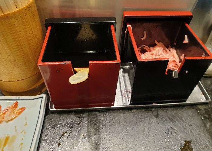 Red and black lacquer boxes with soy sauce and gari