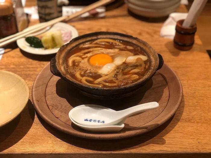 Miso Nikomi Udon, a Nagoya red miso dish of udon noodles topped with a raw egg