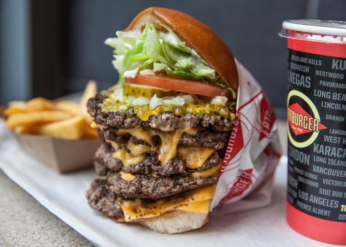 Enormous burger from Fatburger, dripping in cheese with a side of fries
