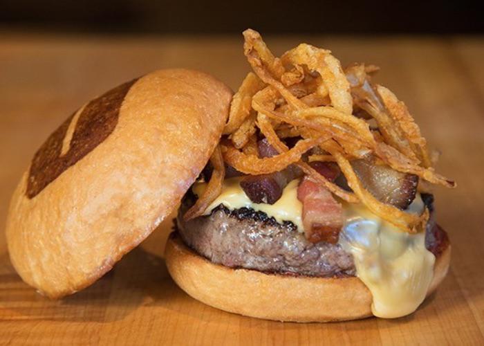 Beef patty topped with bacon bits from Umami Burger