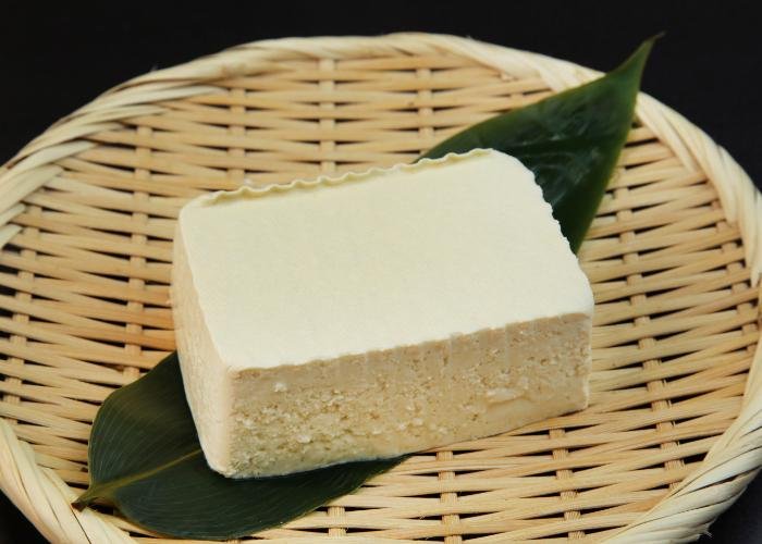 Momen tofu laid out on a bamboo zaru