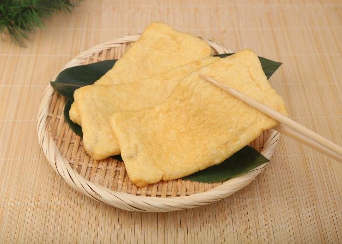 Aburaage fried tofu laid out on a bamboo zaru