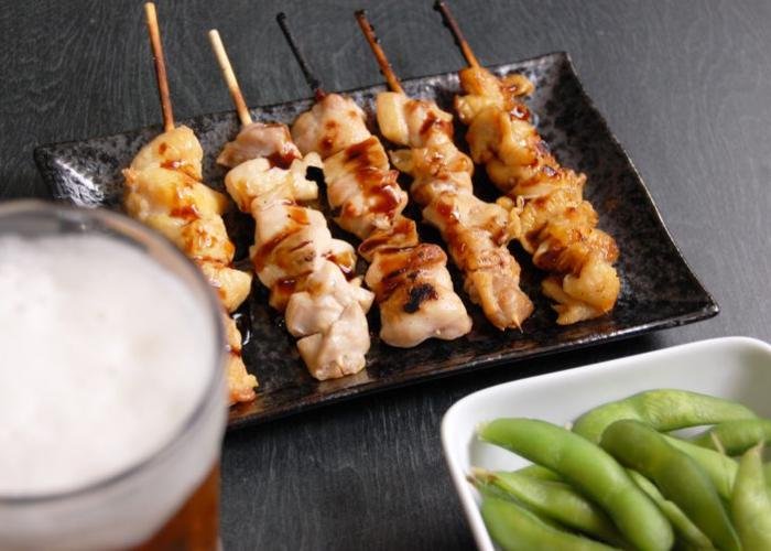Yakitori grilled chicken skewers lined up on a plate