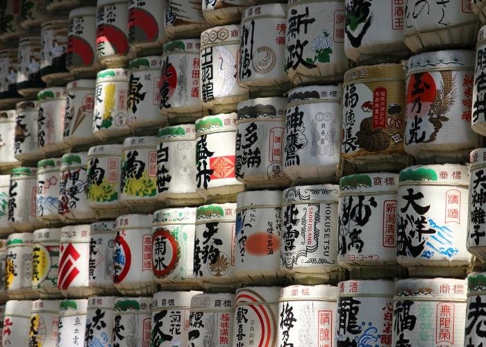 Wall of Japanese sake barrels at shrine or temple