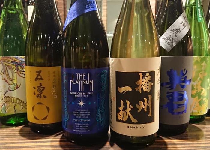 Line-up of sake bottles at Kuri Sake