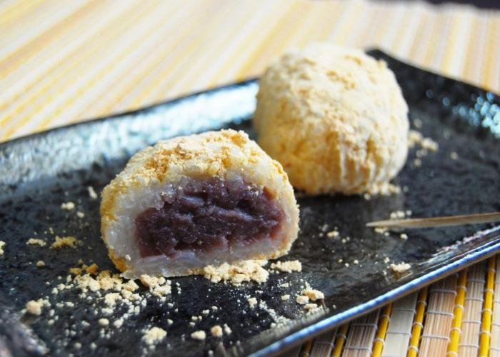 Japanese mochi coated in roasted soybean powder and filled with red bean paste