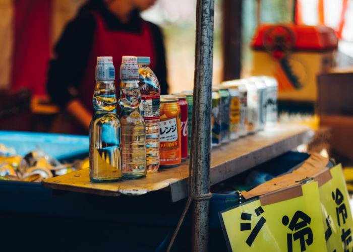 A stall sells Ramune, a popular drink in Japan, in a distinct bottle