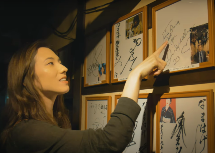 Shizuka points out David Beckham's signature and photo at the Akita Namahage Restaurant in Ginza 