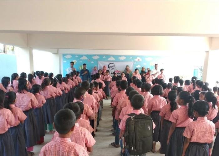Children in a classroom in Bangladesh wearing neat school uniforms donated through byFood's Food for Happiness program