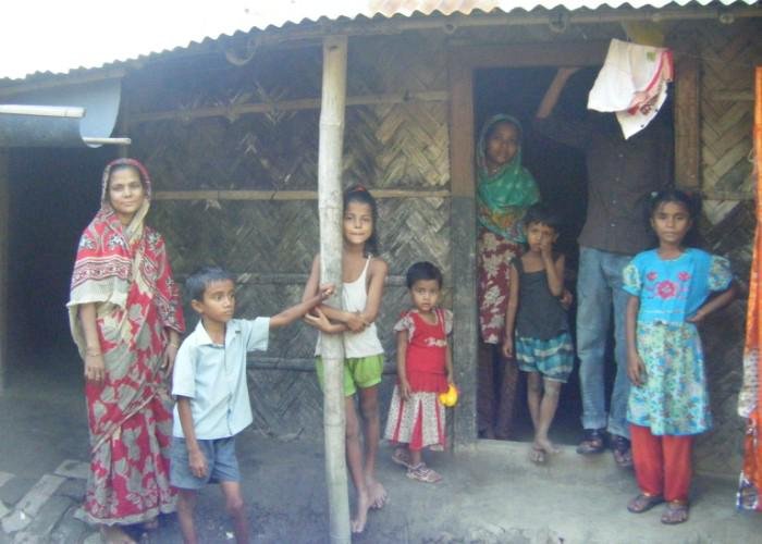 Children in Bangladesh stand outside a house