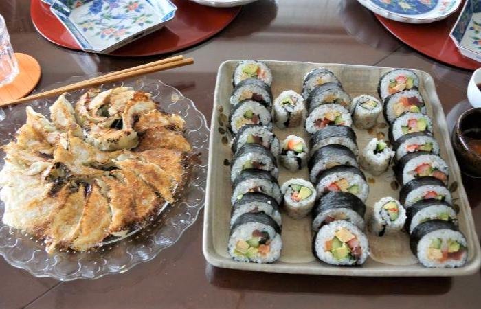 Platter of pan-fried dumplings (gyoza) and colorful Japanese sushi rolls