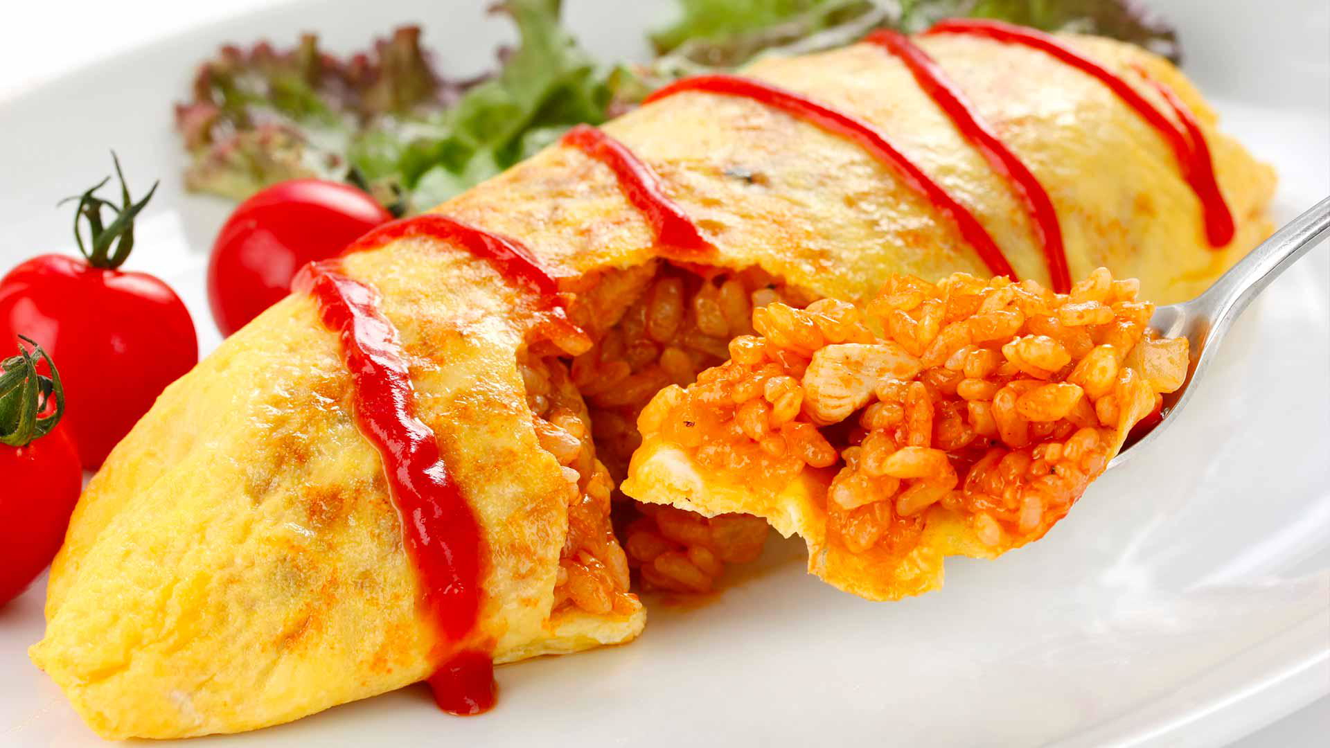 Delicious omurice with tomato rice filling drizzled with ketchup