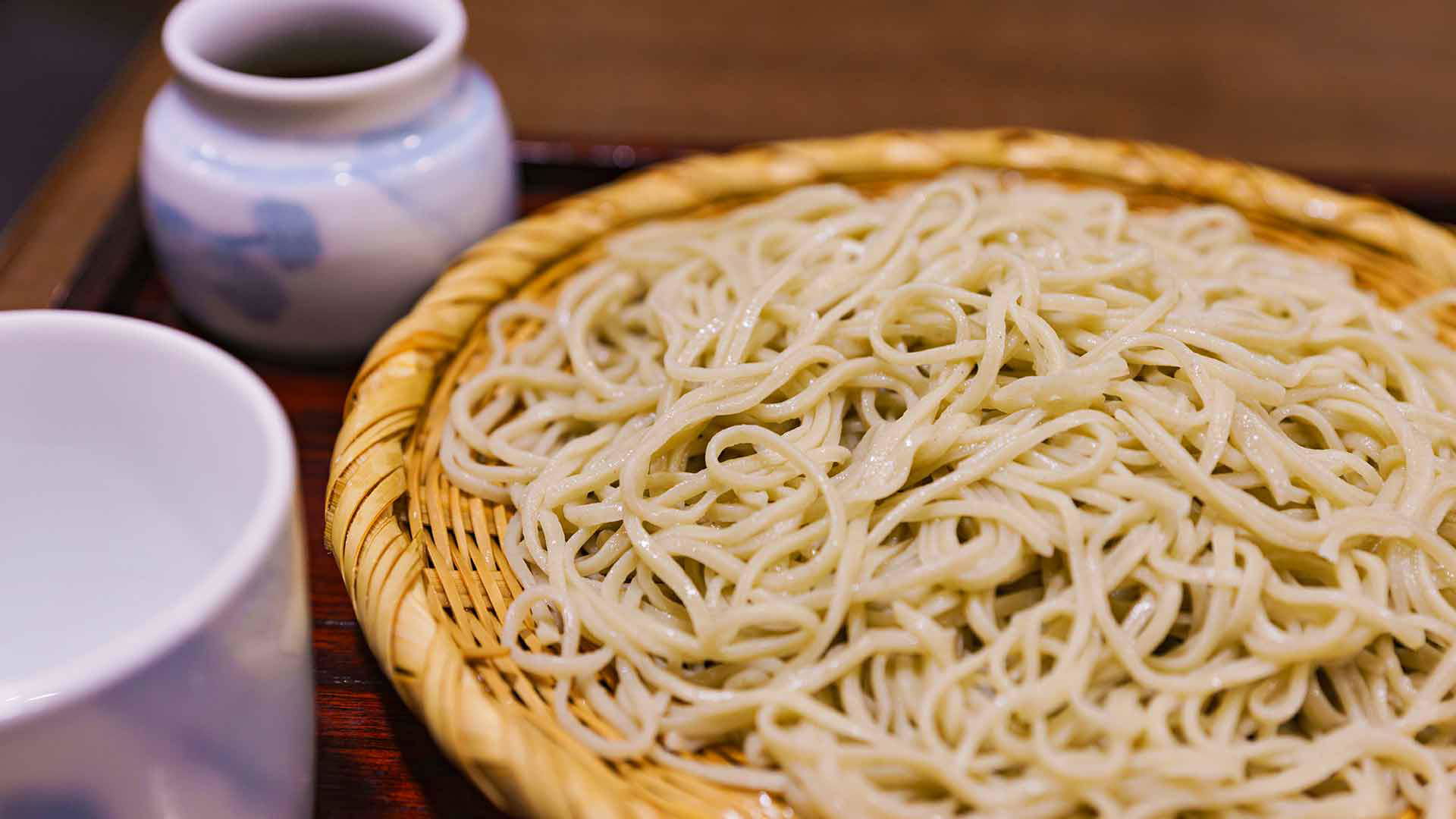 Freshly cooked soba noodles served in a traditional bamboo tray