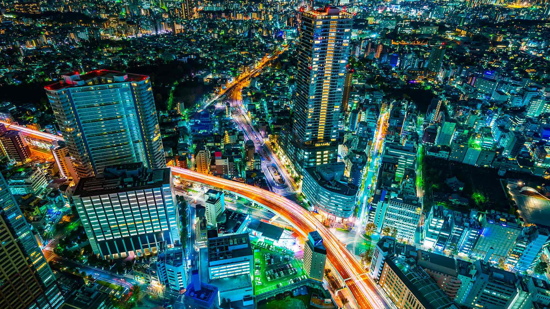 Vibrant cityscape with illuminated skyscrapers and bustling streets