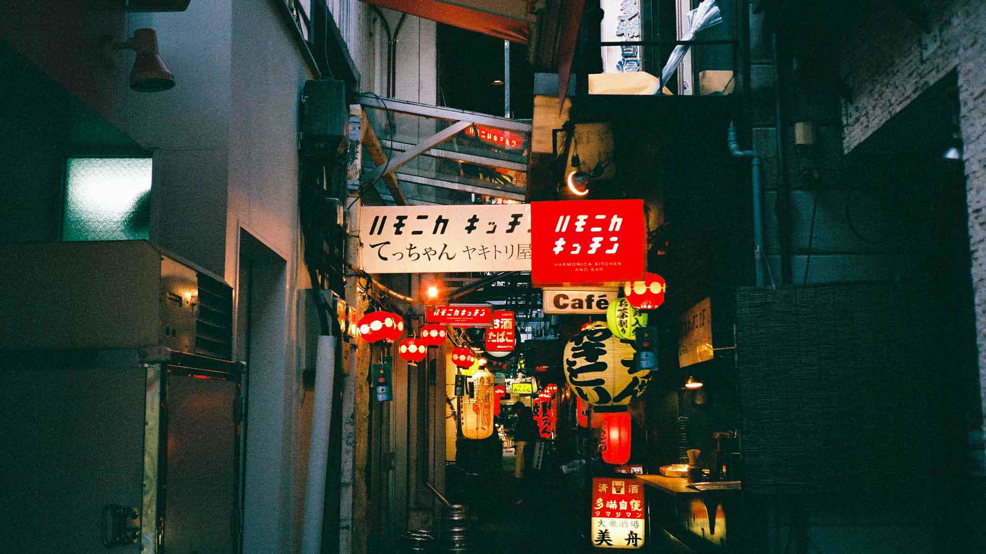 Neon-lit alleyway in Tokyo at night, vibrant street signs illuminate the path