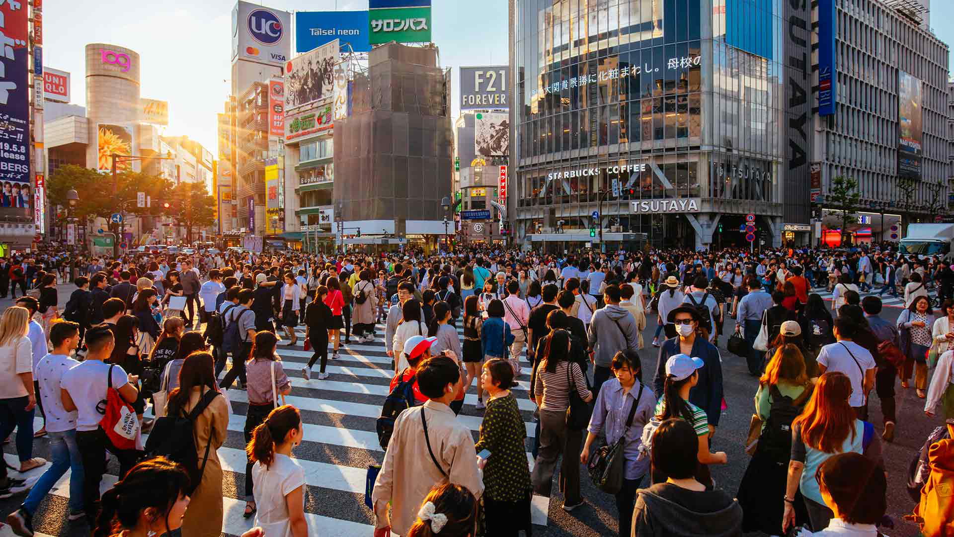 Busy Shibuya Crossing at sunset, capturing vibrant urban life.