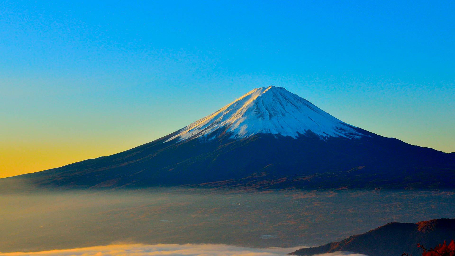 Stunning view of Mount Fuji at sunrise with clear blue skies